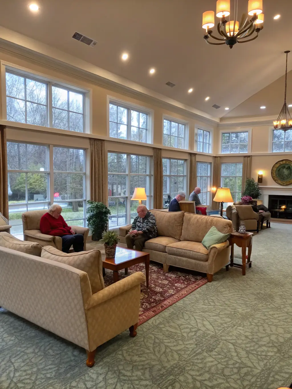 A clean and cheerful common area in an aged care facility, with residents comfortably engaging in activities, reflecting a safe and pleasant living environment maintained by JSC.